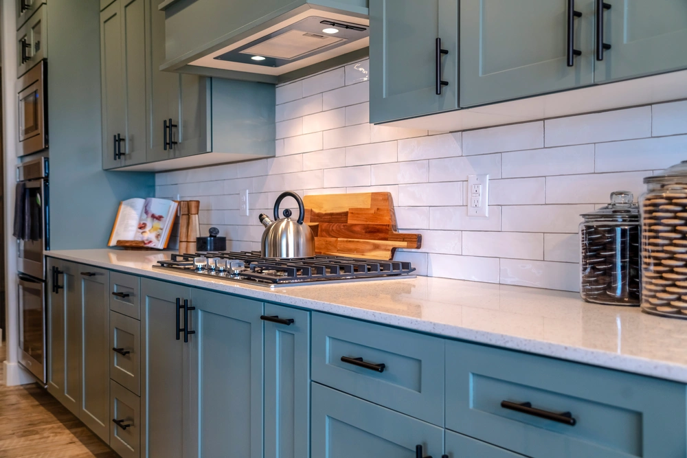 Modern kitchen remodel in Incline Village featuring a light blue cabinetry with a stylish subway tile backsplash.